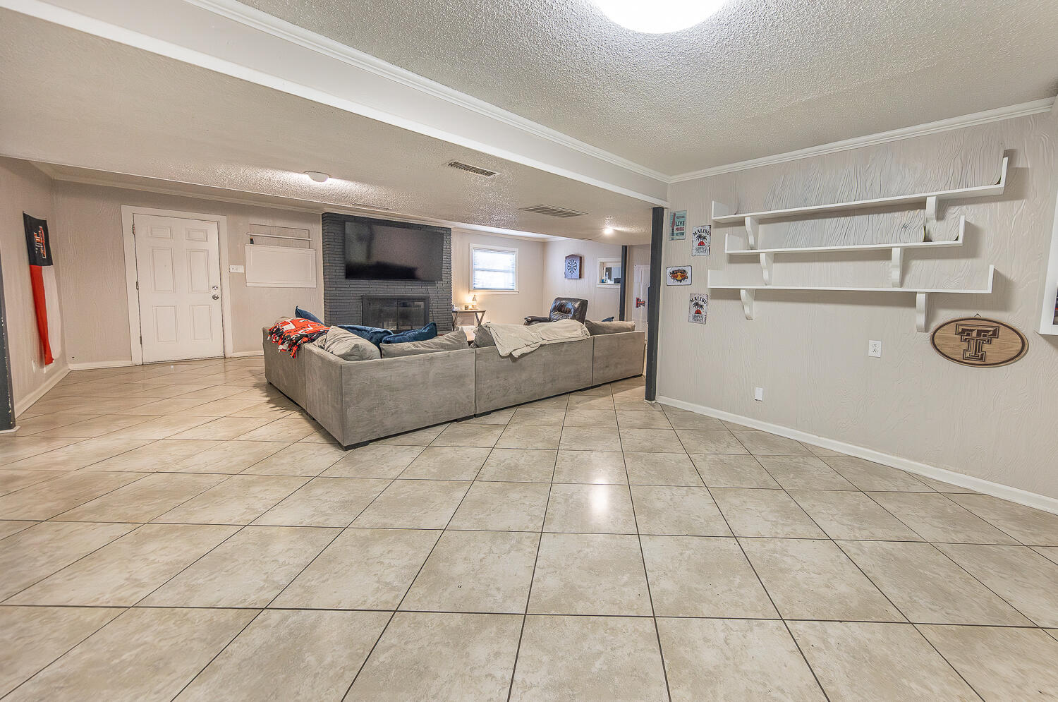 2301 27th Street Lubbock, TX 79411 - Photo 9 of 22 a living room with furniture and a fireplace