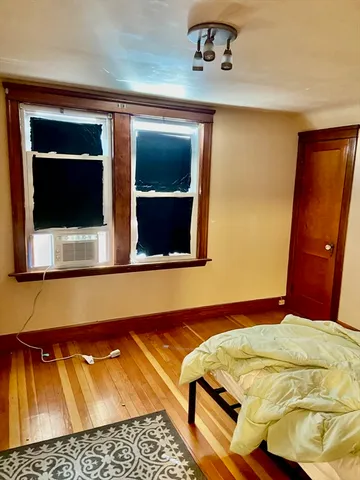 a bedroom with a bed and a window