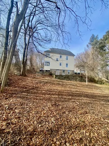 a front view of a house with outdoor seating