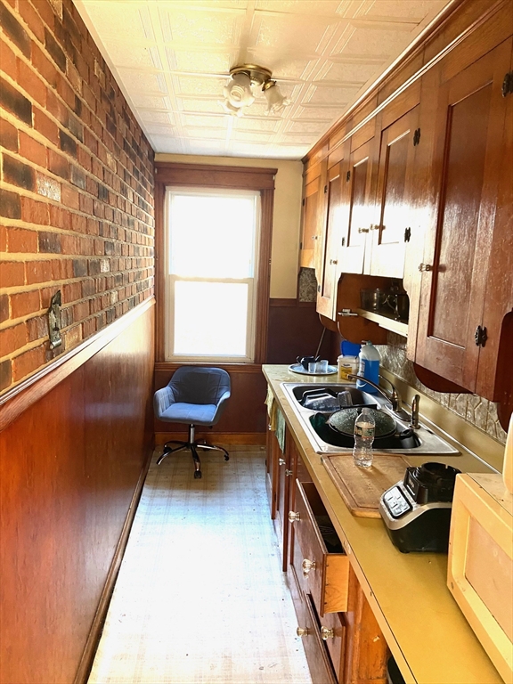 7 3rd Avenue Dudley, MA 01571 - Photo 7 of 19 a kitchen with a stove and a refrigerator