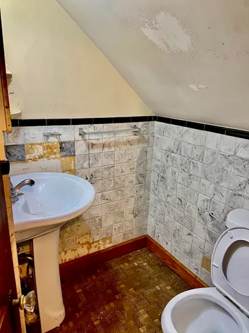 a bathroom with a sink a toilet and a mirror