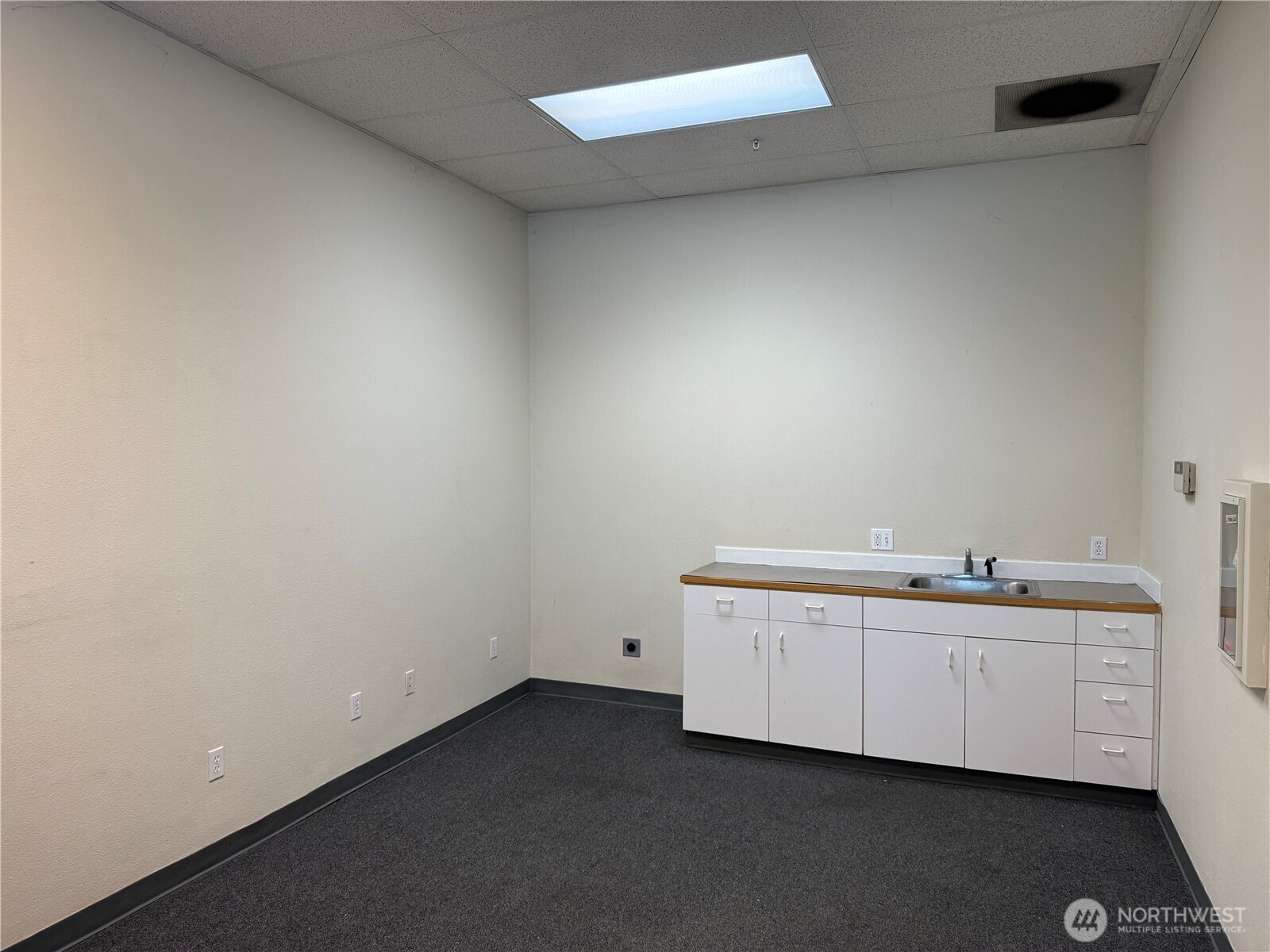 3837 Aurora Avenue North, Unit 100 Seattle, WA 98103 - Photo 4 of 6 a room with a sink and cabinets
