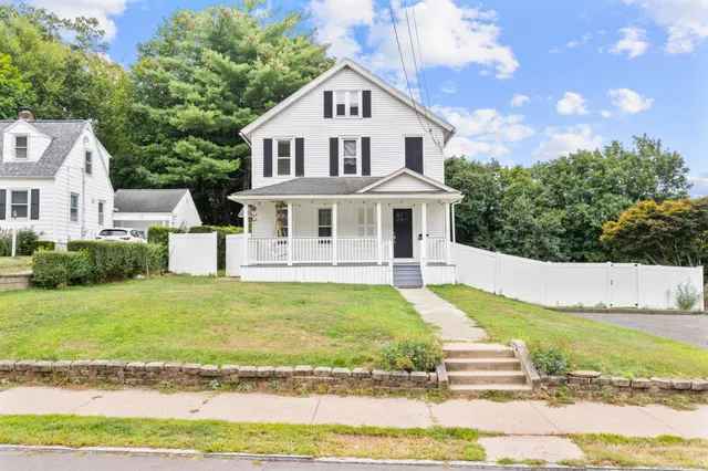 a front view of a house with a yard