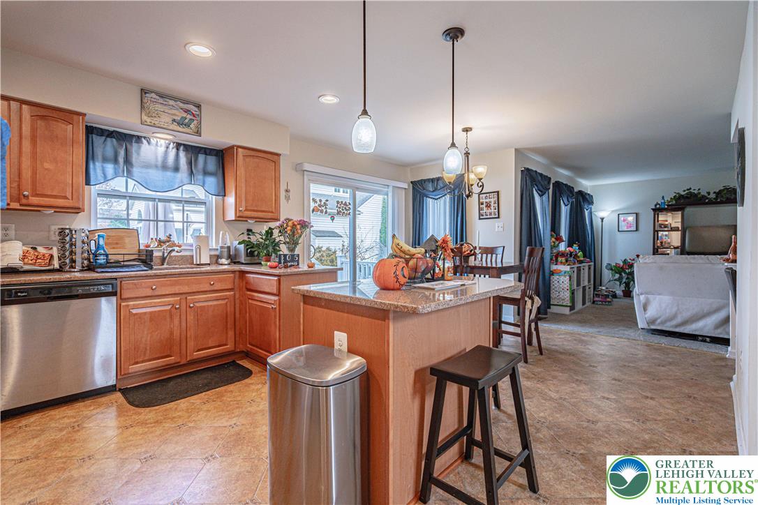 1120 Tyler Way Bethlehem, PA 18017 - Photo 15 of 67 a kitchen with stainless steel appliances granite countertop a kitchen island a stove a table and chairs