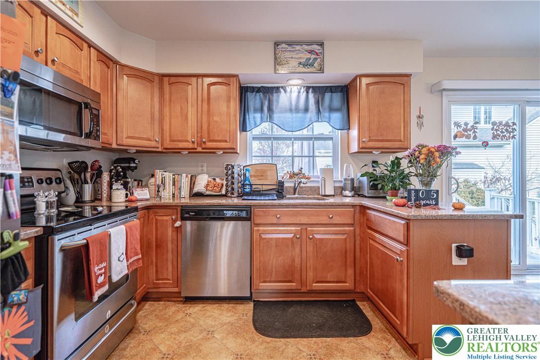 1120 Tyler Way Bethlehem, PA 18017 - Photo 16 of 67 a kitchen with stainless steel appliances granite countertop a refrigerator a sink a stove and a microwave