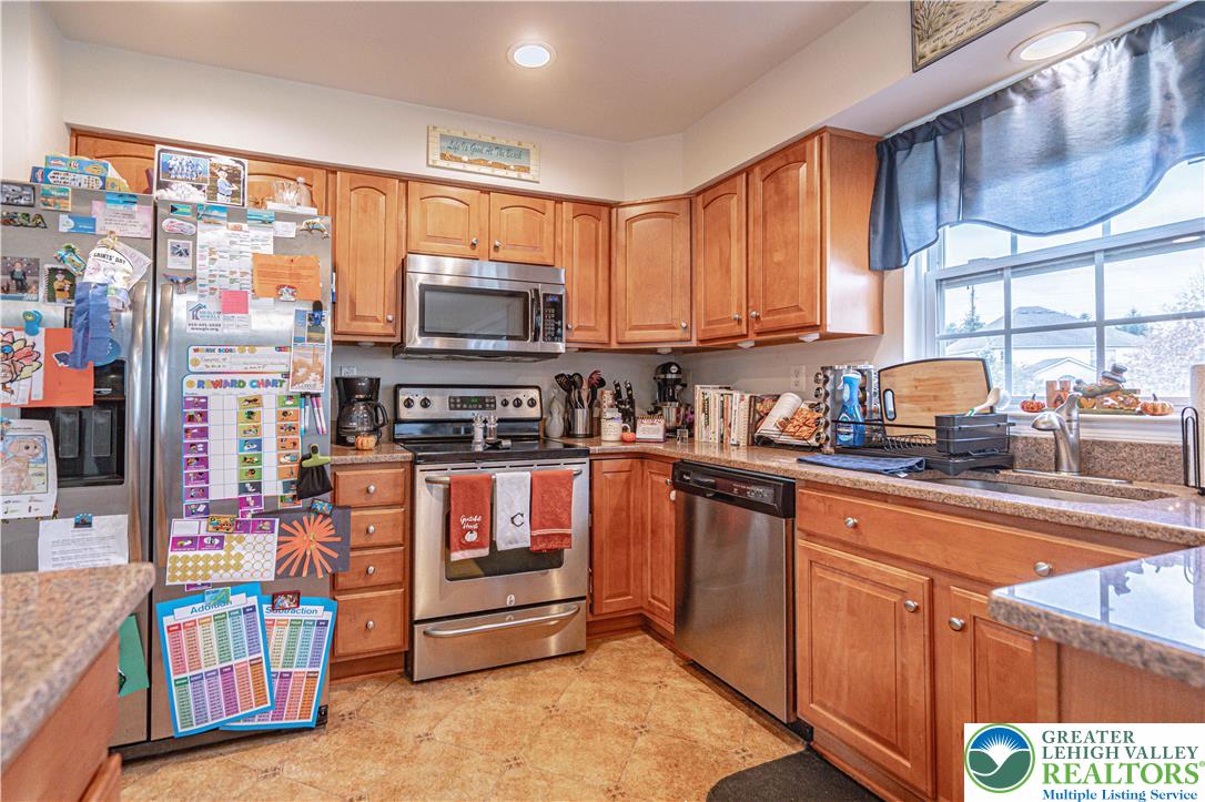 1120 Tyler Way Bethlehem, PA 18017 - Photo 17 of 67 a kitchen with stainless steel appliances granite countertop a stove a sink and a microwave