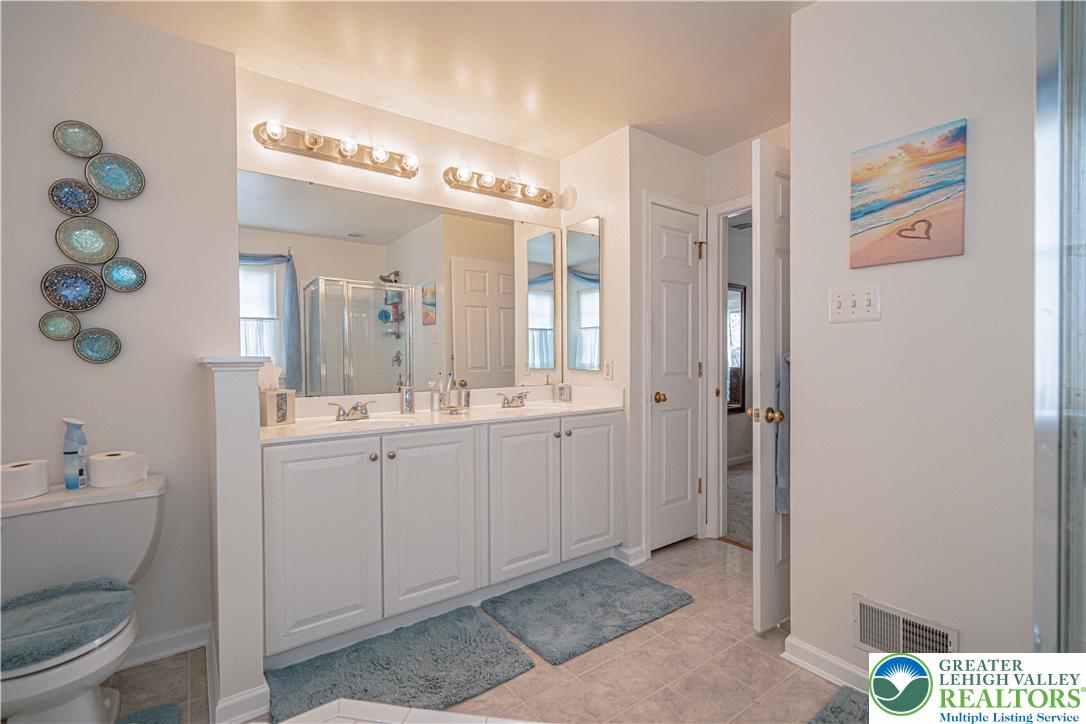 1120 Tyler Way Bethlehem, PA 18017 - Photo 33 of 67 a spacious bathroom with a granite countertop sink a toilet and a mirror