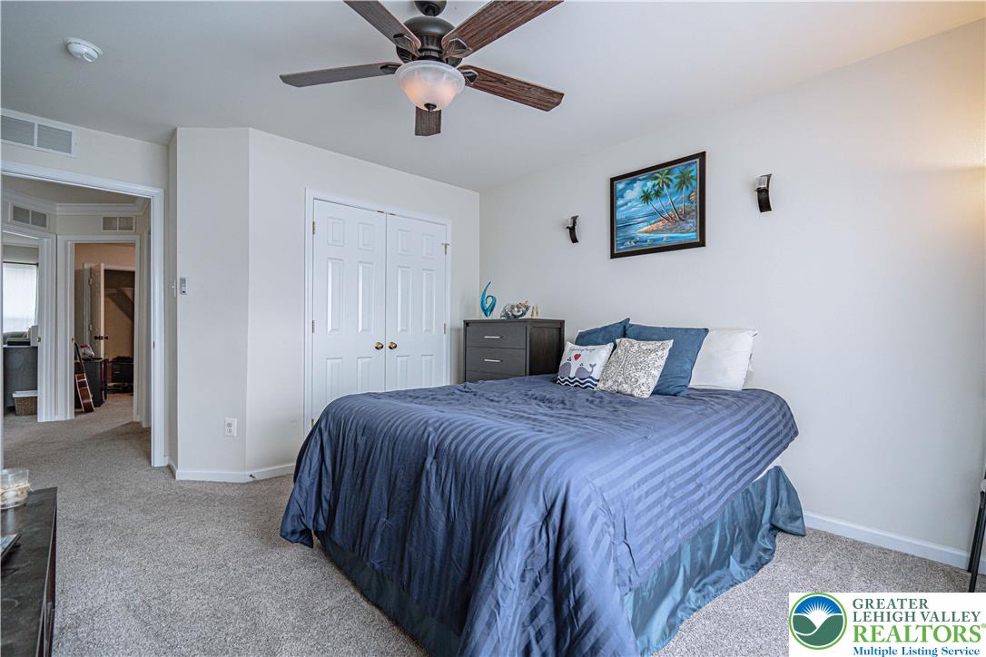 1120 Tyler Way Bethlehem, PA 18017 - Photo 41 of 67 a bedroom with a bed and a chandelier