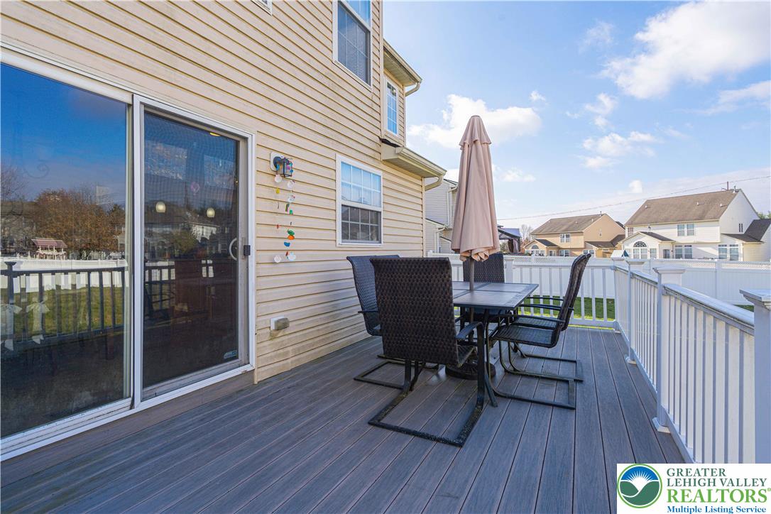 1120 Tyler Way Bethlehem, PA 18017 - Photo 52 of 67 a view of a roof deck with table and chairs with wooden floor and fence
