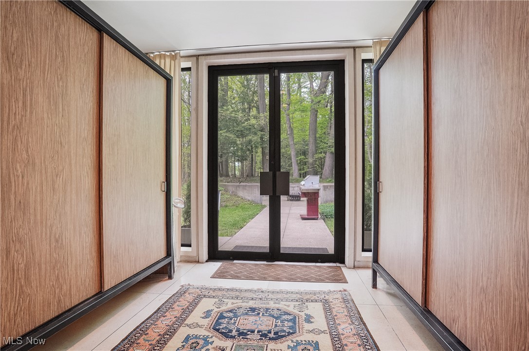 3210 North Dover Road Stow, OH 44224 - Photo 34 of 44 Doorway to outside with expansive windows and light tile patterned flooring
