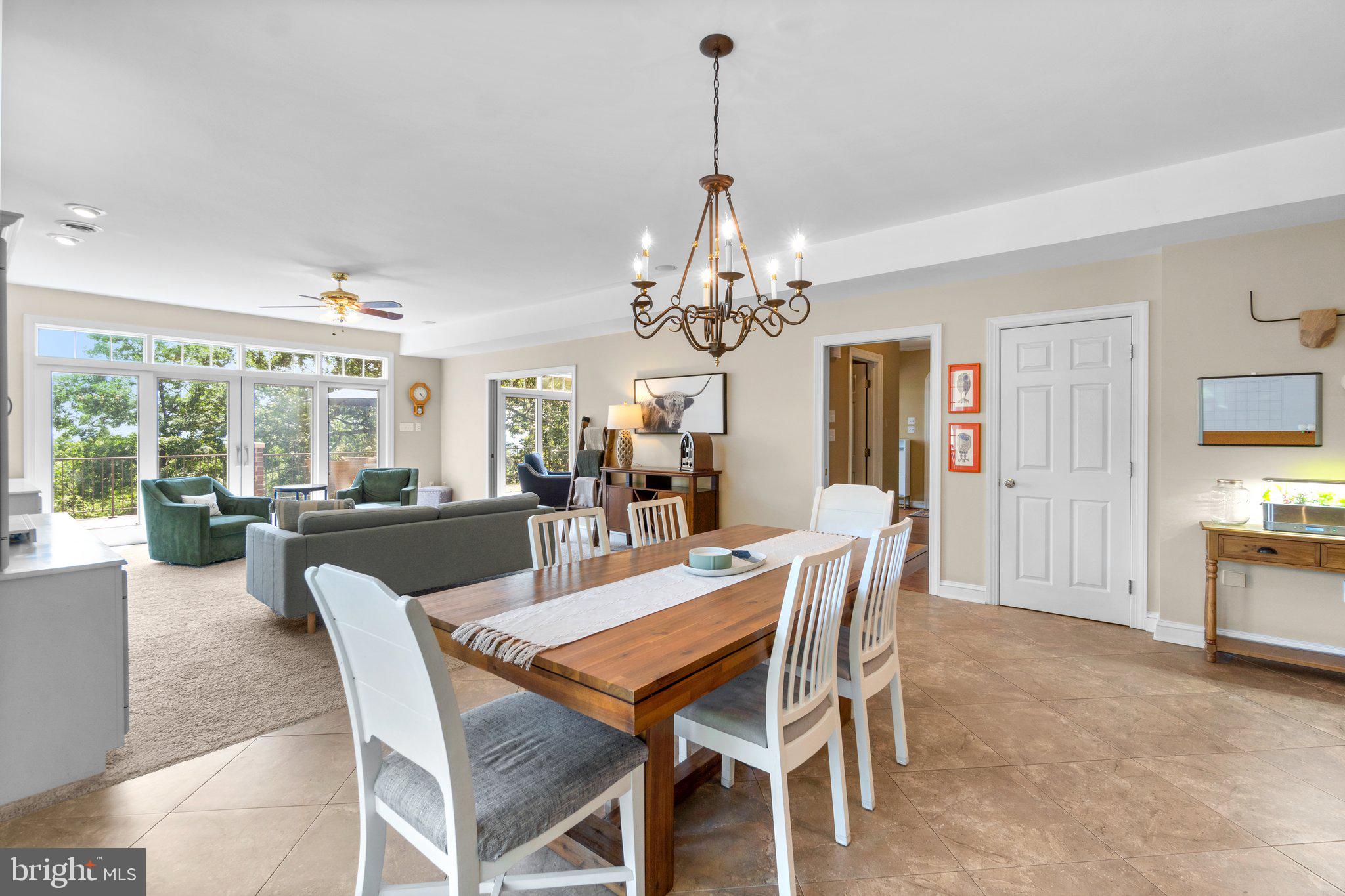 7341 Kehne Road Frederick, MD 21702 - Photo 14 of 67 a view of a dining room with furniture a chandelier and large windows