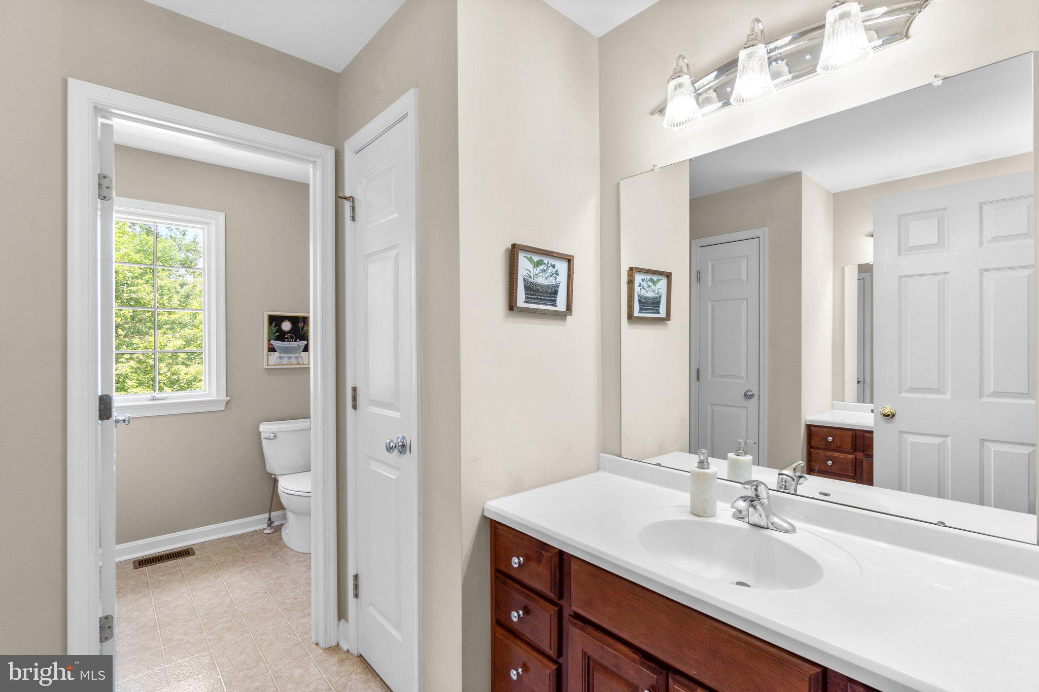 7341 Kehne Road Frederick, MD 21702 - Photo 31 of 67 a bathroom with a sink vanity and a mirror