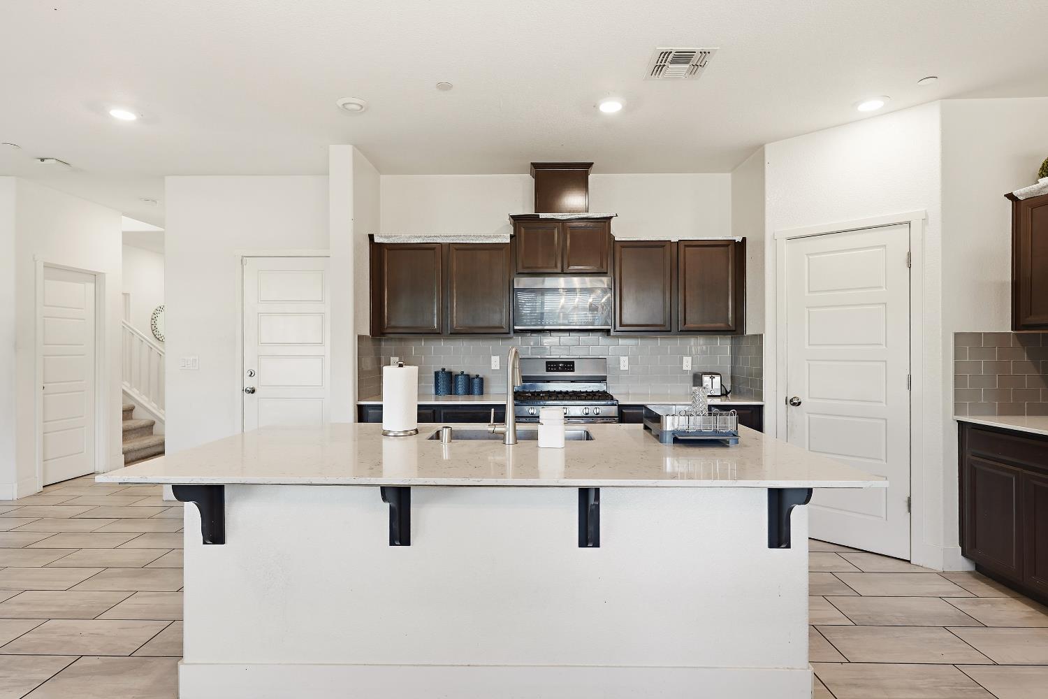 2367 Explorador Drive Merced, CA 95340 - Photo 15 of 42 a kitchen with stainless steel appliances a refrigerator stove microwave and cabinets