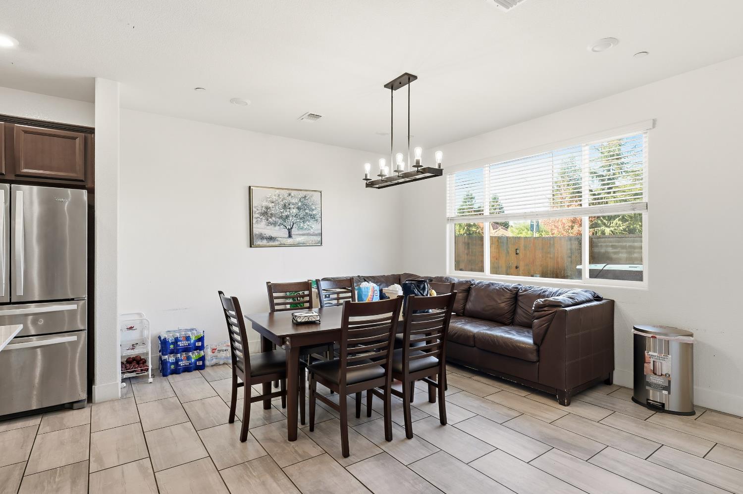 2367 Explorador Drive Merced, CA 95340 - Photo 16 of 42 a dining room with furniture a chandelier and window