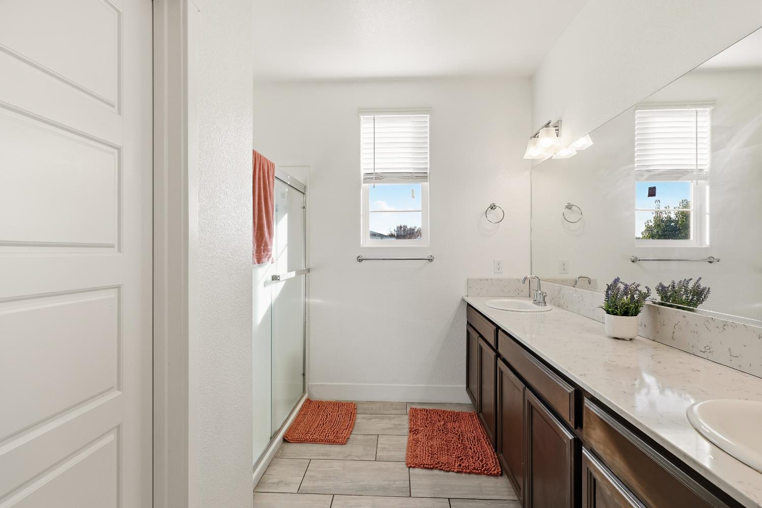 2367 Explorador Drive Merced, CA 95340 - Photo 22 of 42 a bathroom with a sink a mirror and a shower