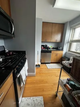 a kitchen with stainless steel appliances granite countertop a stove and a sink