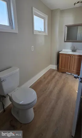 a white toilet sitting next to a bathroom sink
