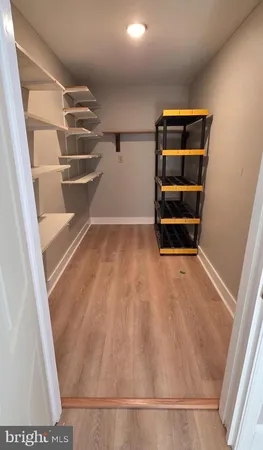 a view of walk in closet with empty racks