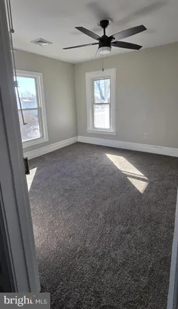 a view of an empty room with closet