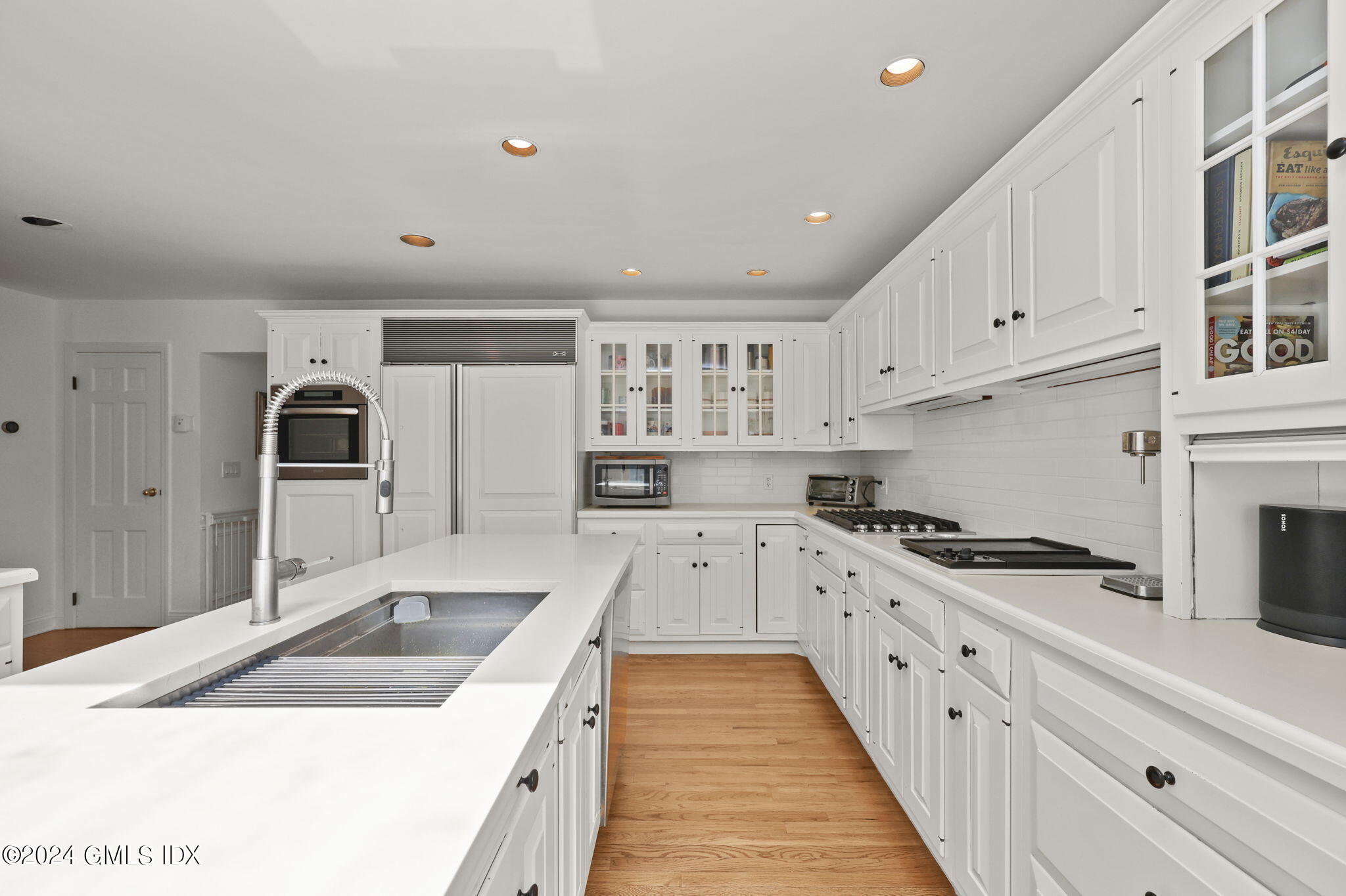 72 Lockwood Road Riverside, CT 06878 - Photo 11 of 51 a kitchen with granite countertop a sink stove and cabinets