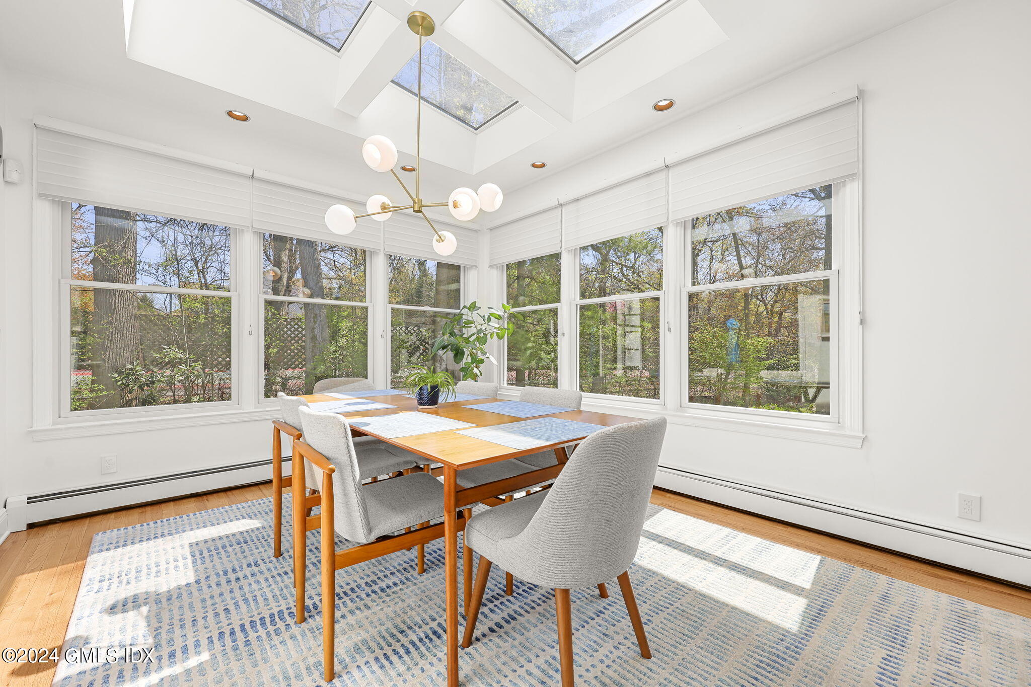 72 Lockwood Road Riverside, CT 06878 - Photo 13 of 51 a view of a dining room with furniture large windows and wooden floor