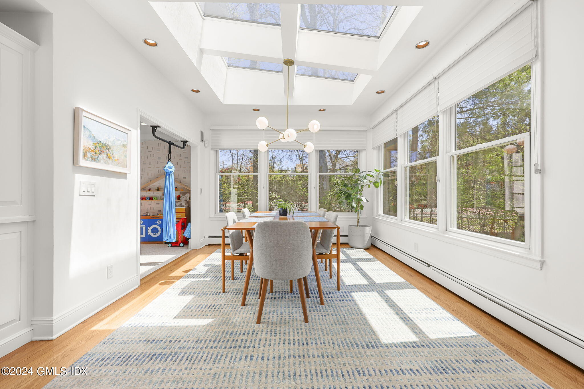 72 Lockwood Road Riverside, CT 06878 - Photo 14 of 51 a dining room with furniture a chandelier and wooden floor