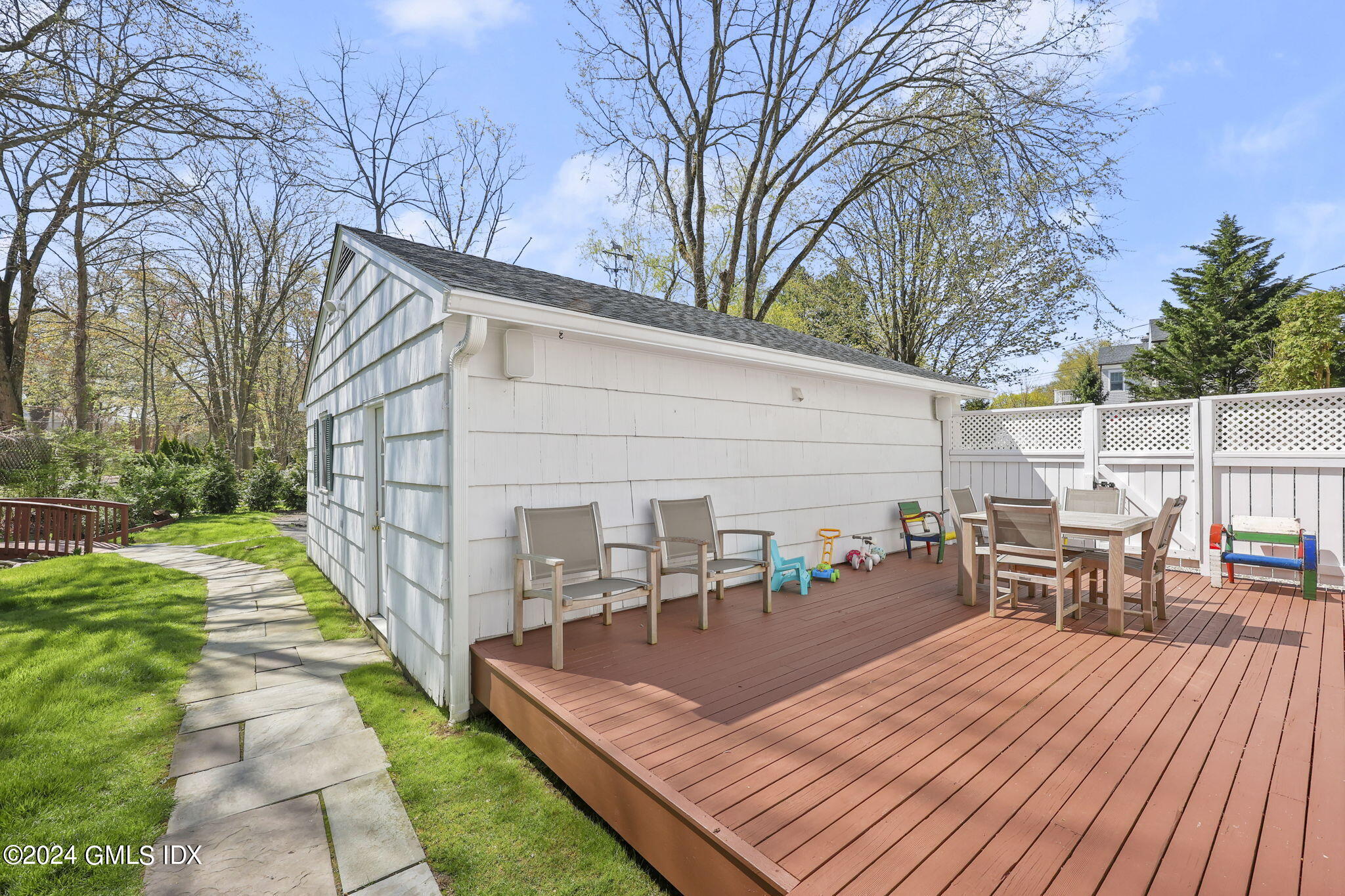 72 Lockwood Road Riverside, CT 06878 - Photo 43 of 51 a view of a patio with dining table and chairs with wooden floor and fence