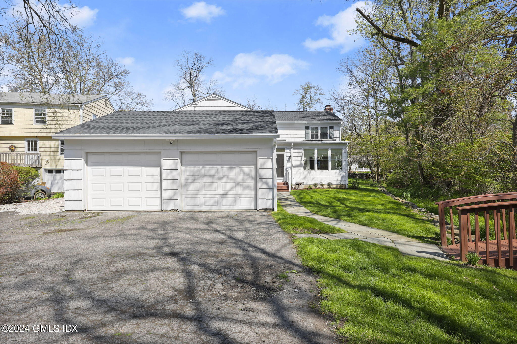 72 Lockwood Road Riverside, CT 06878 - Photo 46 of 51 a front view of a house with a yard and garage