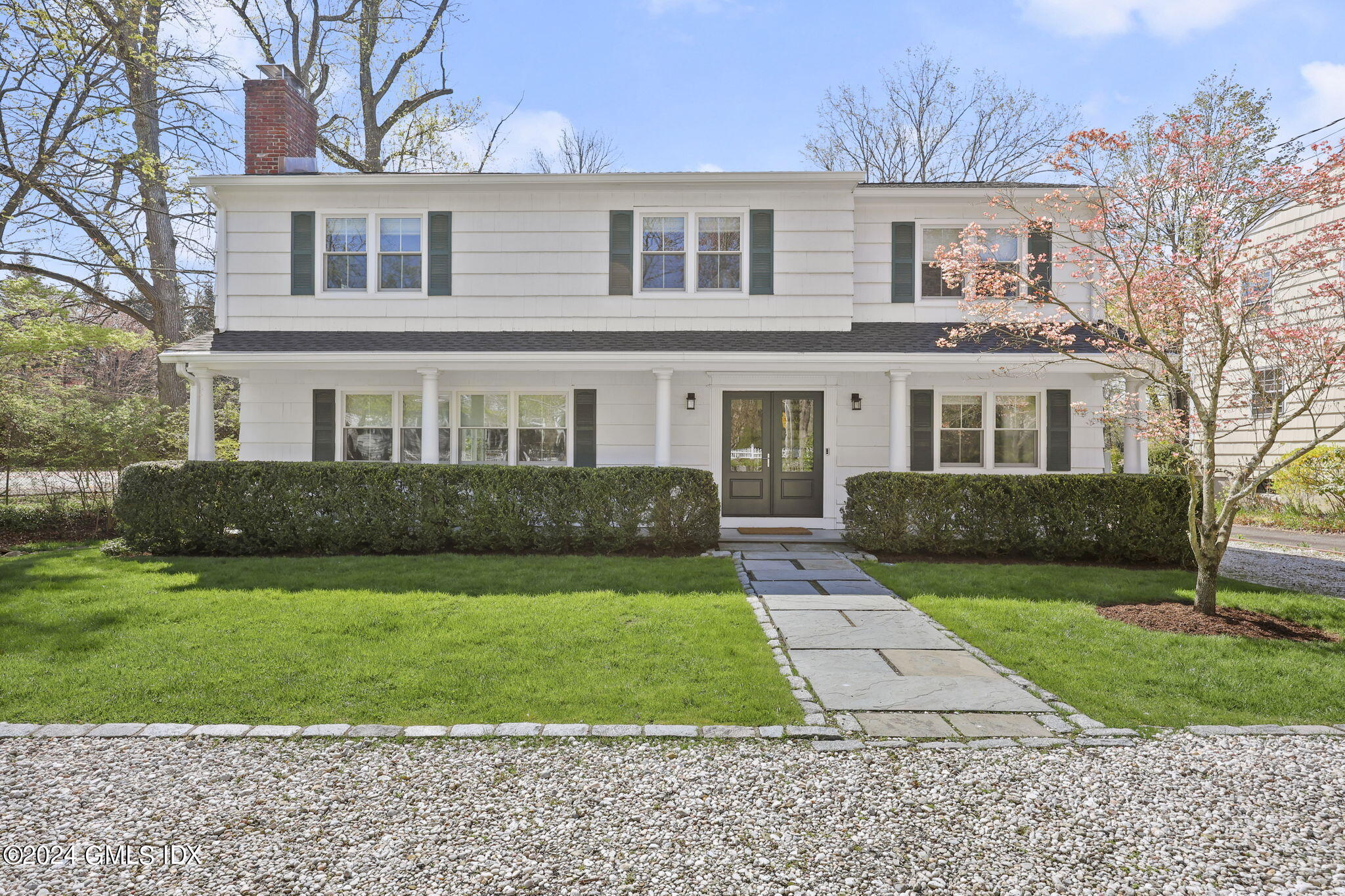 72 Lockwood Road Riverside, CT 06878 - Photo 49 of 51 a front view of a house with a yard and garage