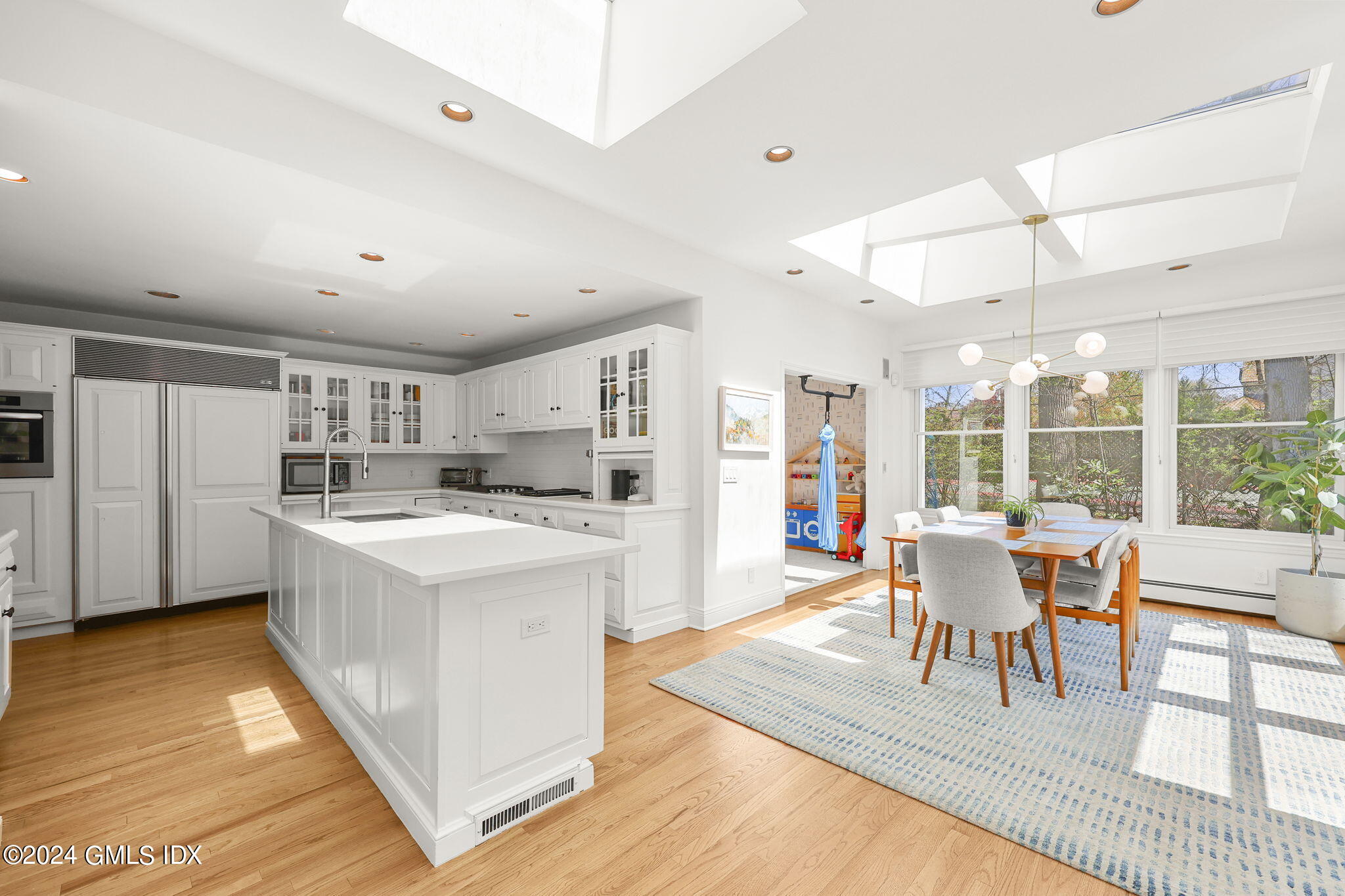 72 Lockwood Road Riverside, CT 06878 - Photo 9 of 51 a living room with stainless steel appliances kitchen island granite countertop a table chairs and a view of living room