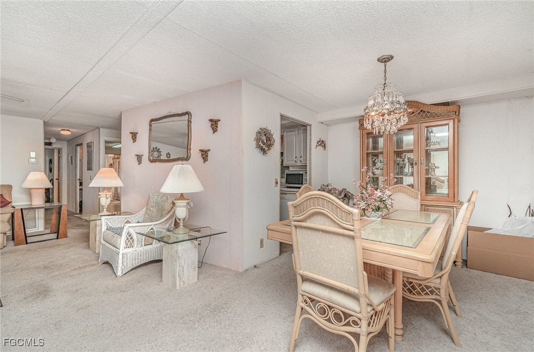 5 Aloe Alva, FL 33920 - Photo 11 of 37 a view of a dining room with furniture and chandelier