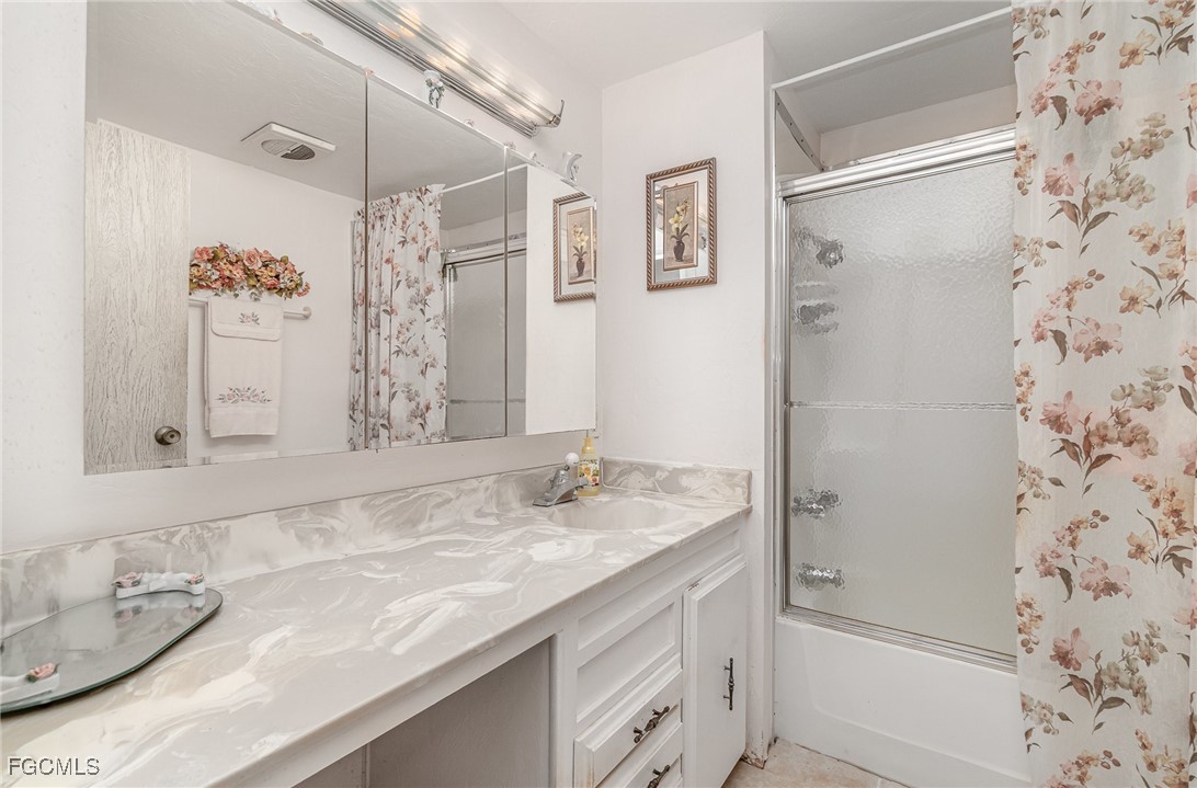 5 Aloe Alva, FL 33920 - Photo 17 of 37 a bathroom with a granite countertop sink toilet and shower