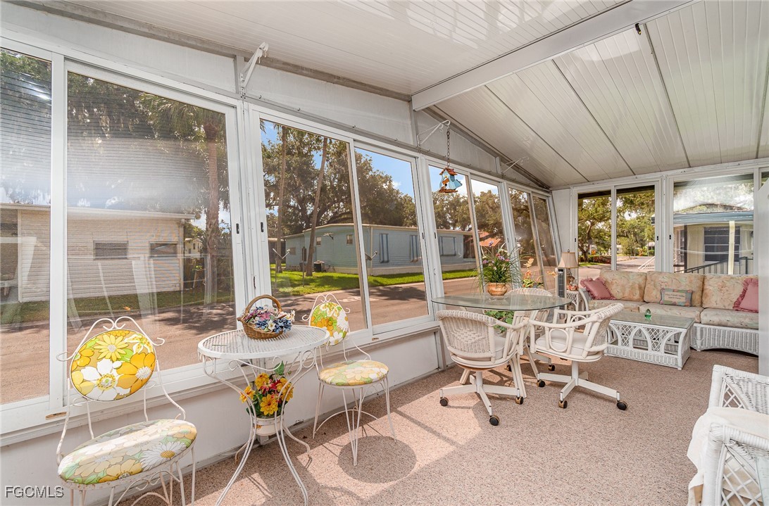 5 Aloe Alva, FL 33920 - Photo 19 of 37 a living room with patio area furniture and a floor to ceiling window