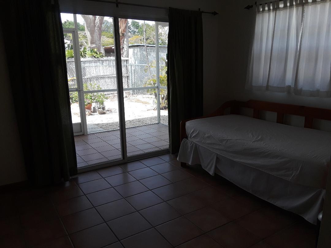 14 Jewfish Avenue Key Largo, FL 33037 - Photo 23 of 44 a spacious bedroom with a bed and a window