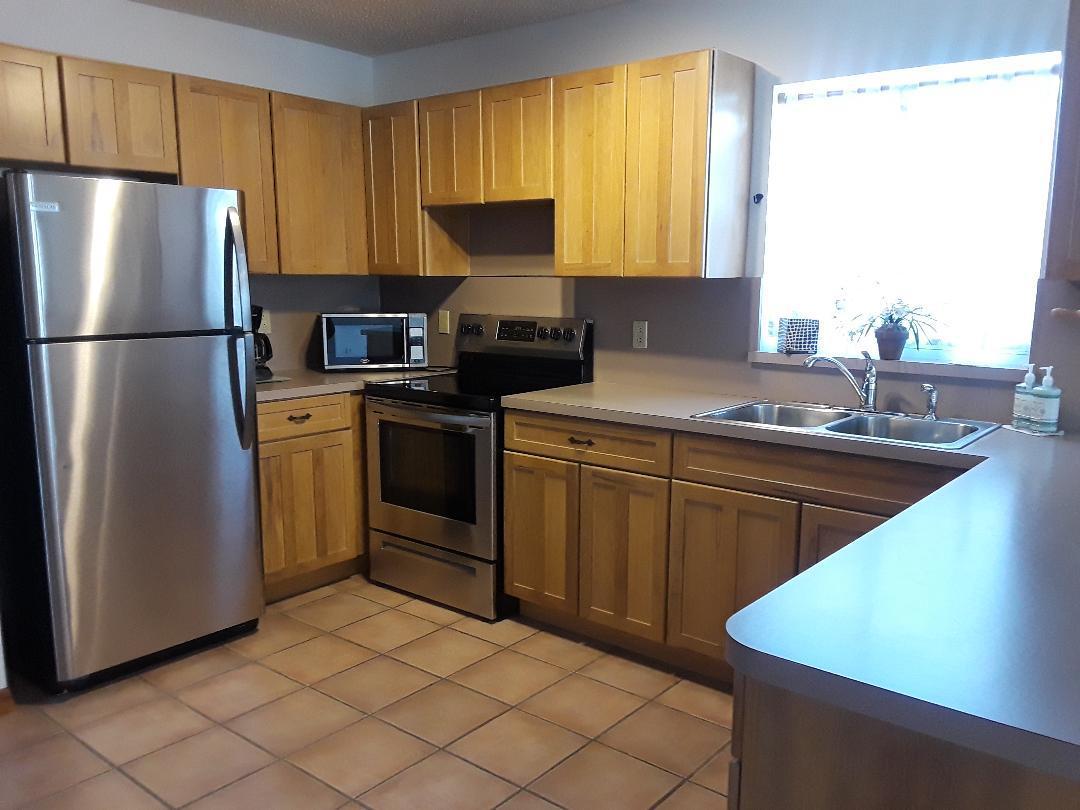 14 Jewfish Avenue Key Largo, FL 33037 - Photo 25 of 44 a kitchen with stainless steel appliances granite countertop a sink stove refrigerator and cabinets