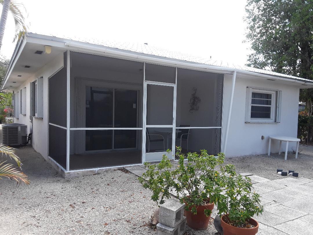 14 Jewfish Avenue Key Largo, FL 33037 - Photo 29 of 44 a front view of a house with a yard