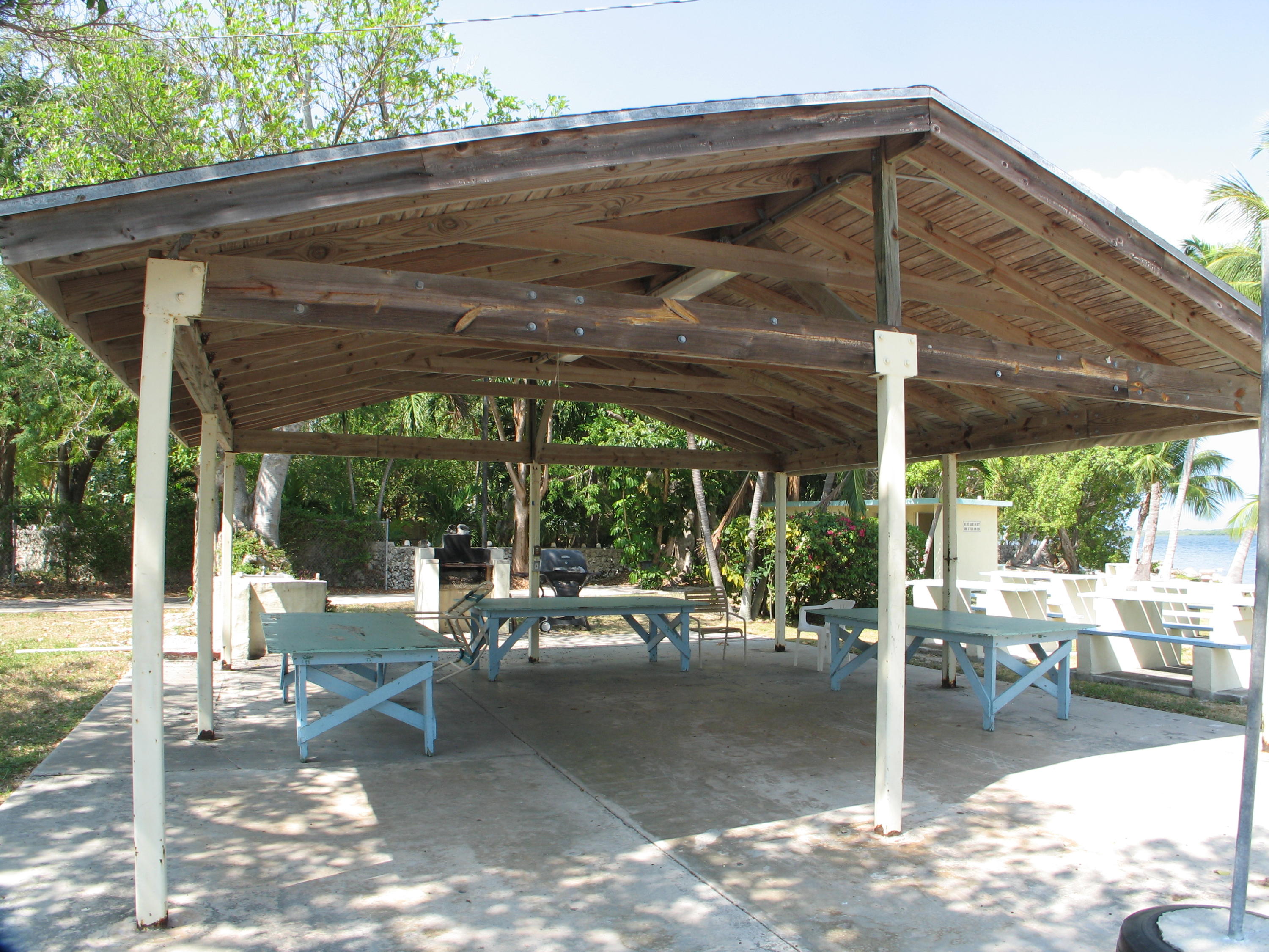 14 Jewfish Avenue Key Largo, FL 33037 - Photo 37 of 44 a patio with a table and chairs under an umbrella