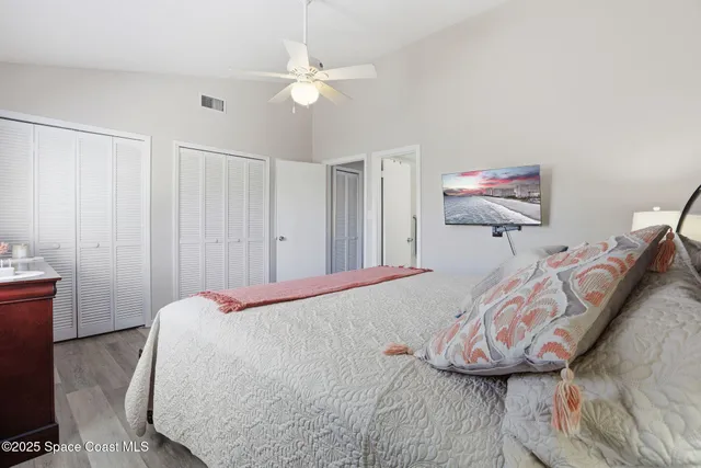 a bathroom with a granite countertop sink mirror vanity and toilet