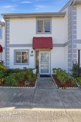 a view of a brick house with a yard
