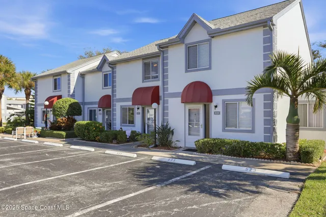 a front view of multiple houses with yard