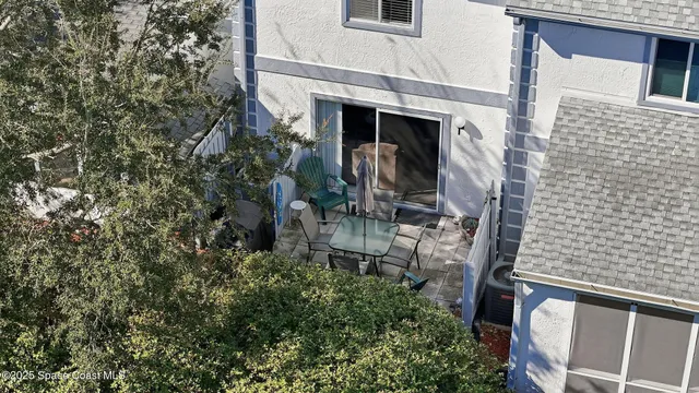 an aerial view of multiple houses with yard