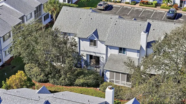 an aerial view of a city with lots of residential buildings ocean and mountain view in back