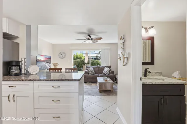 a bathroom with a granite countertop toilet sink and mirror