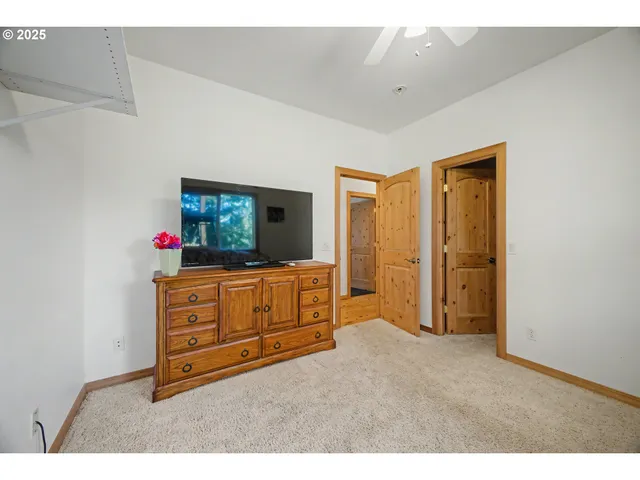 a living room with furniture flat screen tv and a dresser