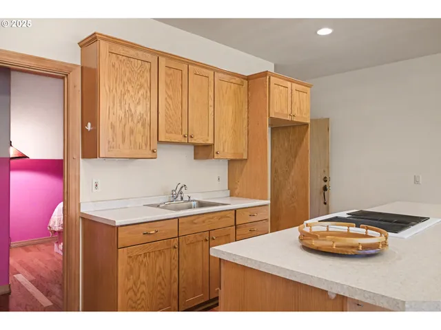 a kitchen with stainless steel appliances a sink dishwasher stove refrigerator and cabinets