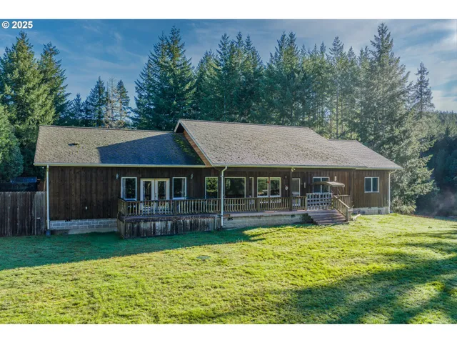 a view of a house with a yard and sitting area