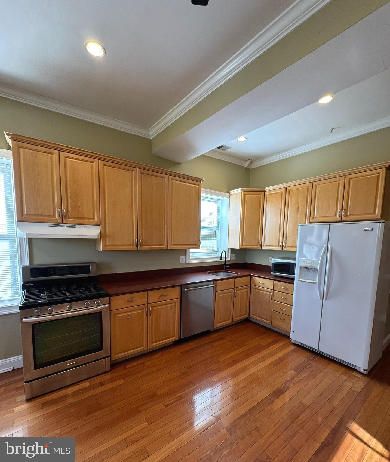 3445 14th Street Northwest, Unit 3 Washington, DC 20010 - Photo 2 of 15 a kitchen with stainless steel appliances granite countertop a stove a sink and a refrigerator