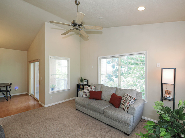 1138 Meadow Fork Road, Unit 7 Provo, UT 84606 - Photo 9 of 27 Living area featuring vaulted ceilings, recessed lighting, a ceiling fan, a large window with blinds, and a sliding glass door