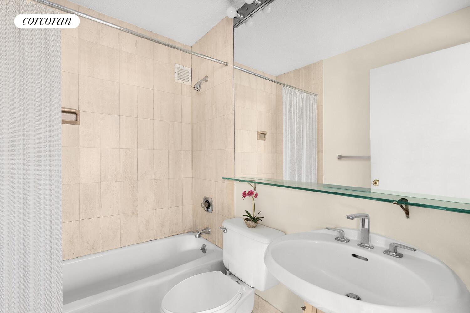 45 West 67th Street, Unit 8E Manhattan, NY 10023 - Photo 4 of 6 a bathroom with a sink toilet and shower