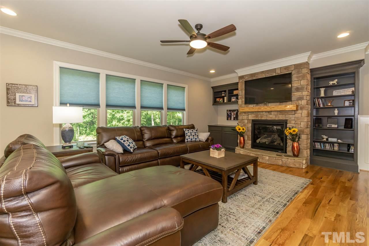 6112 Spring Branch Circle Raleigh, NC 27603 - Photo 11 of 30 a living room with furniture fireplace and a large window